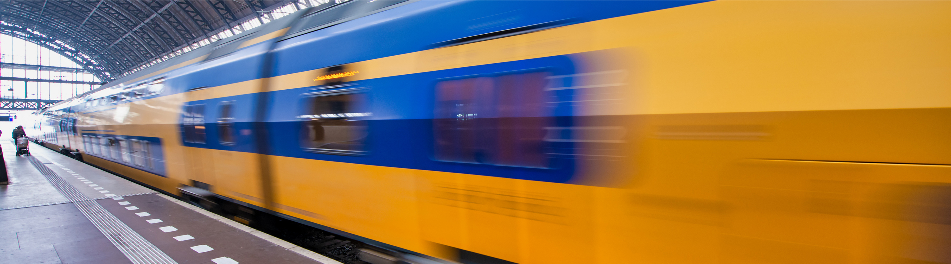 A public transportation train moving through a station