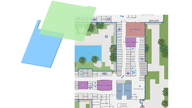 Mappa indoor con punti blu e dati gestiti in un GIS per un grande edificio, con forme colorate.