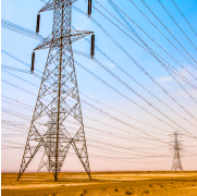 Rows of transmission towers stretching across a dry landscape