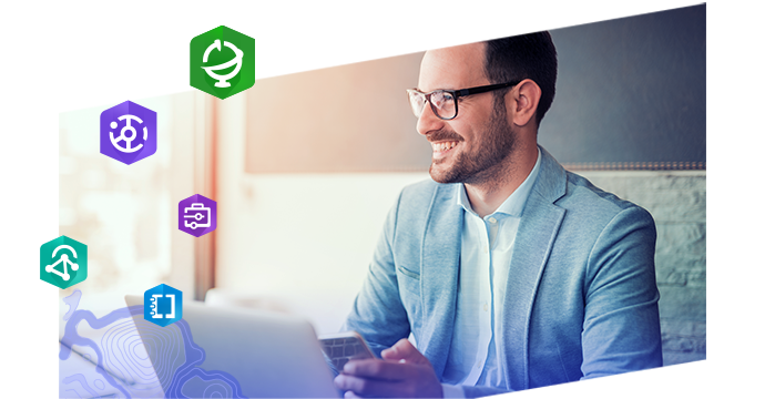 Young professional man with glasses smiling and working on a laptop