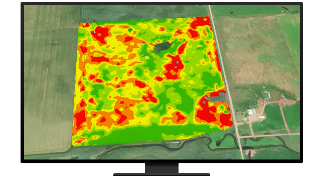 Foto aerea composita di un terreno agricolo verde con una mappa termica sovrapposta in verde, arancione e rosso più luminosi