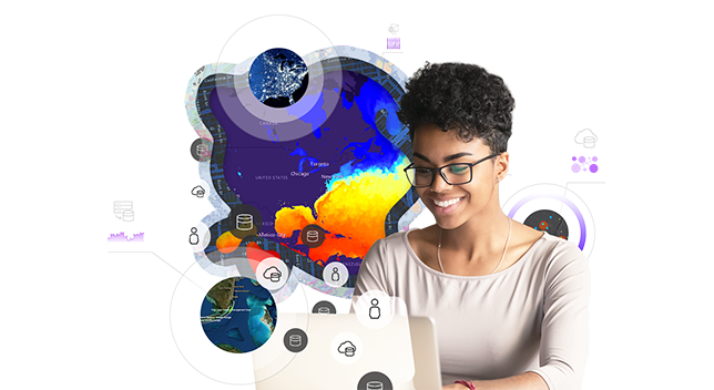 Persona che guarda un computer e mappe che la circondano che indicano cosa sta guardando