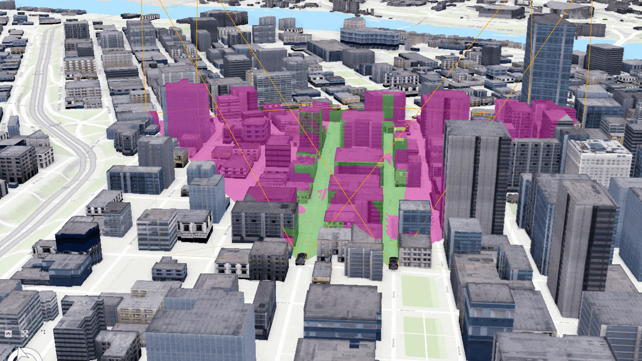 Un modello 3D del centro di una città. Diversi edifici sono evidenziati con sfumature di rosa e verde, che indicano le zone o aree di interesse all'interno della città.