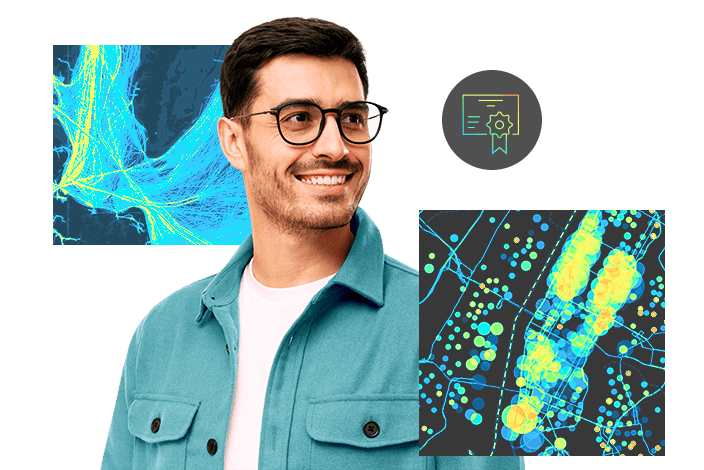 A man in glasses and a blue shirt studies multiple superimposed maps in front of him