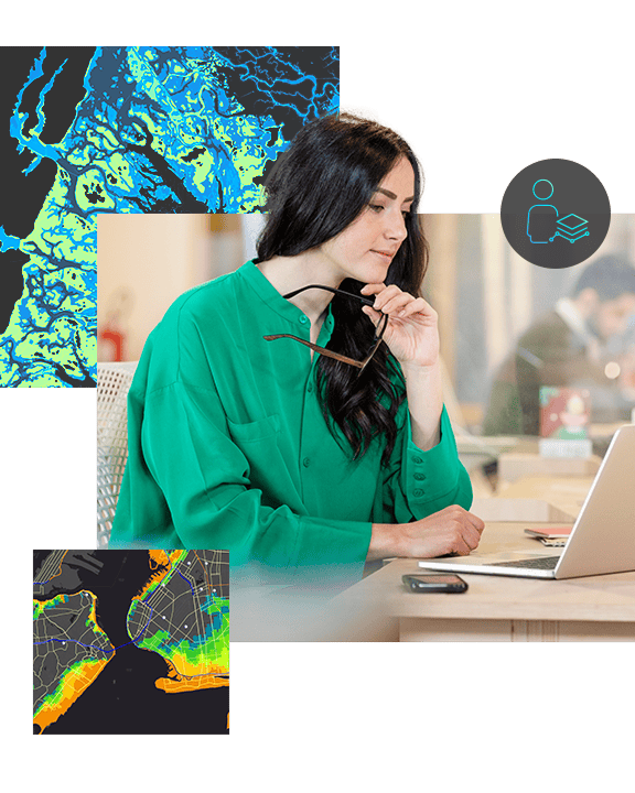 A woman in a green shirt works at a desk with a laptop open, analyzing two map graphics superimposed over a topographic line graphic background
