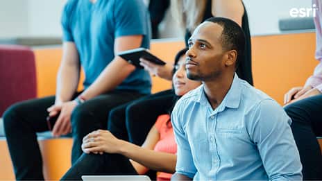 A group of people sitting in a classroom looking forward
