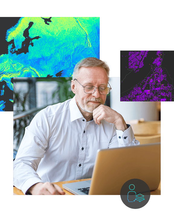 A man wearing glasses sits in front of a laptop with a digital background image of Europe, featuring a city map with topographic lines on the left side