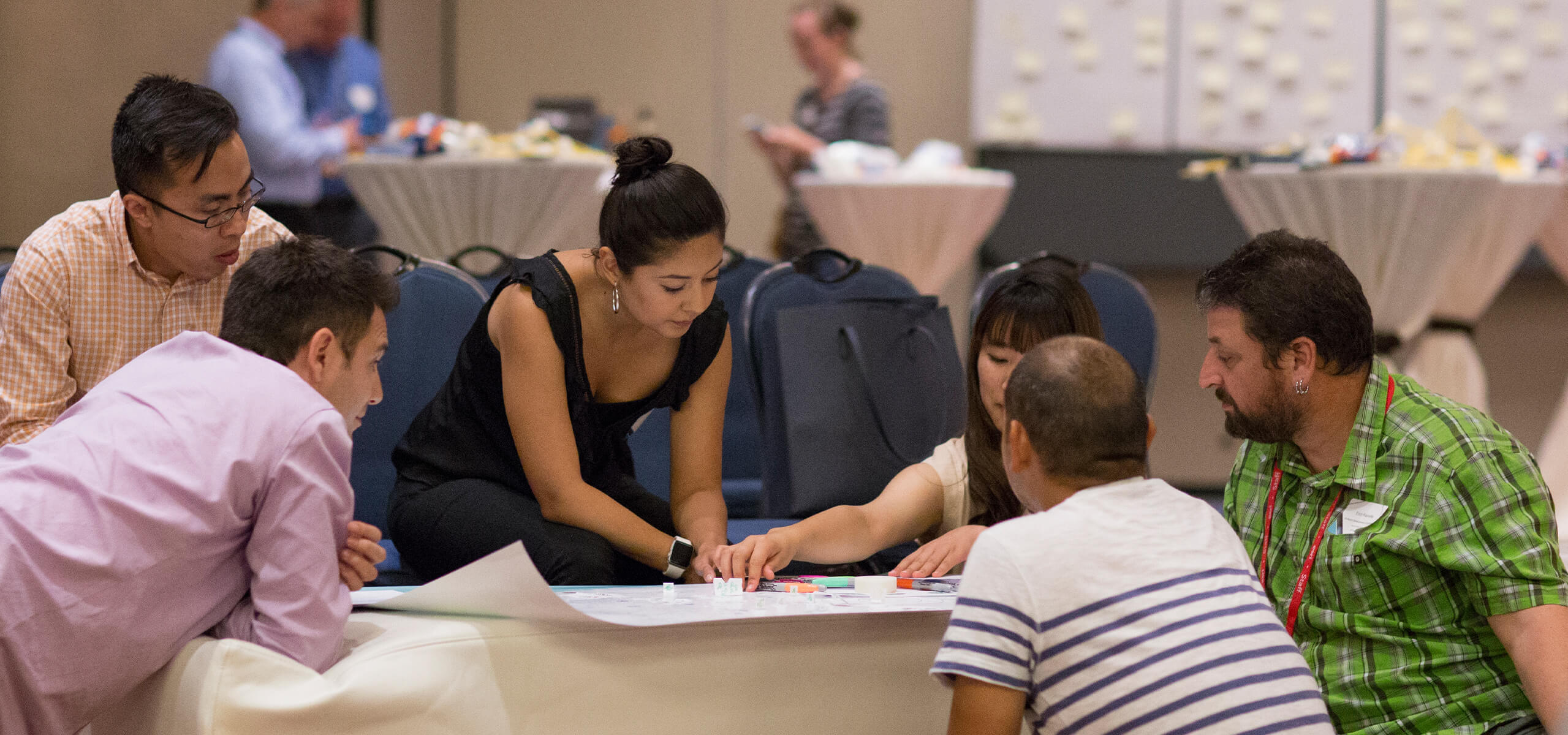 Photo of an Esri employee talking to or researching with a customer